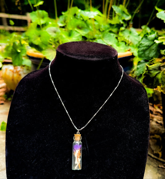 Bottle of bones necklace